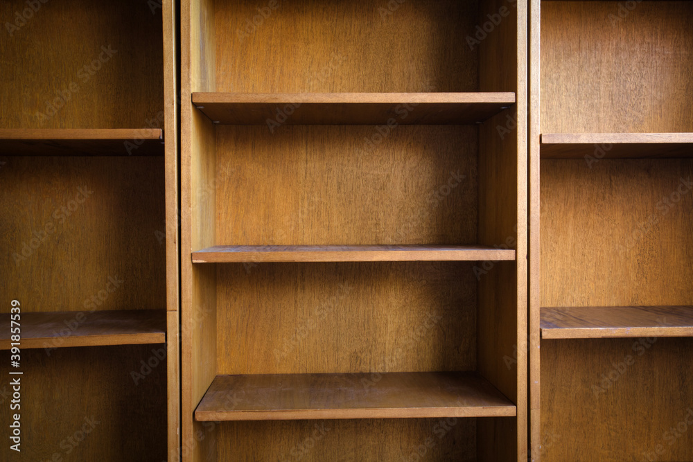 Empty wooden book shelf with or storage rack modern retro design, copy space background texture Empty wooden book shelf with or storage rack modern retro design, copy space background texture