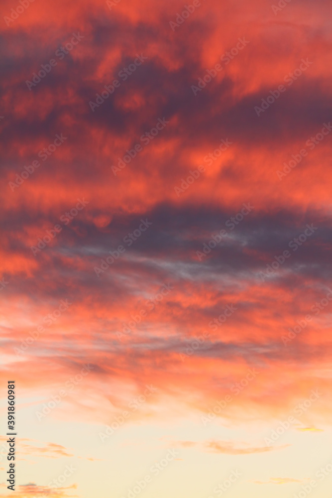 Dramatic red and orange sky and clouds abstract background. Red-orange clouds on sunset sky. Warm weather background.