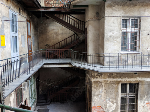 Courtyard of an old, pre-war apartment building with falling plaster