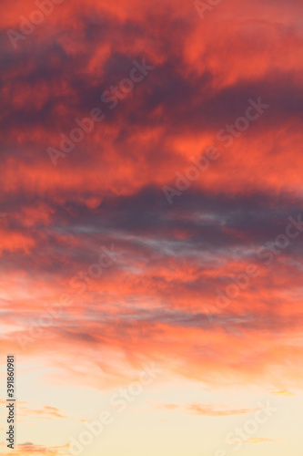 Dramatic red and orange sky and clouds abstract background. Red-orange clouds on sunset sky. Warm weather background.