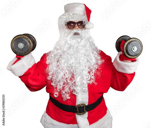 Santa Claus working out and pushing two dumbbells up in the air. Santa wearing sunglasses and a long white beard. Isolated on white background