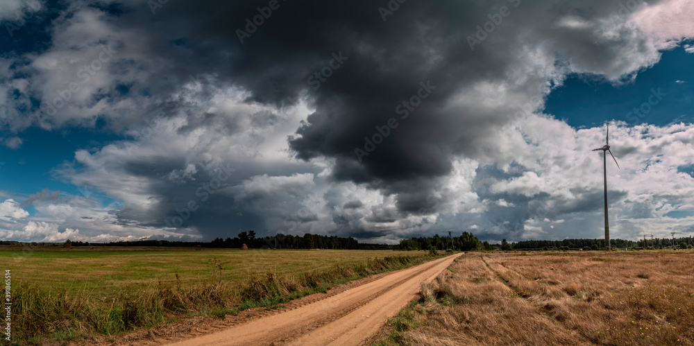 Dramatic view of a shelf cloud over a field, horizontal cloud formation, panorama view.