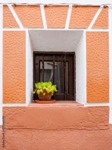 Tiny window with flowerpot. Jaraiz de la Vera, Spain photo