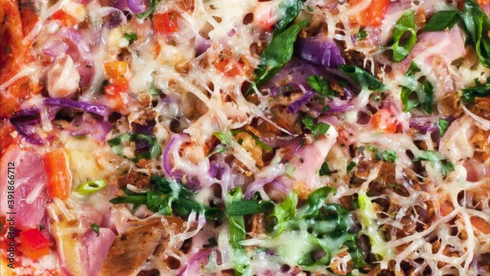 Rotating freshly prepared pizza. View from above. Rotating freshly prepared pizza. View from above.