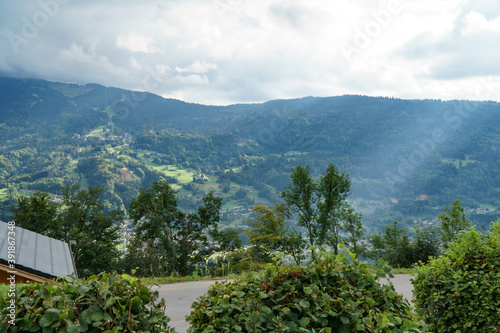 Panorama on moutaies and the Giffre valley, in the French Alps, in summer, with a cloudy sky and a few rays of sunshine.
