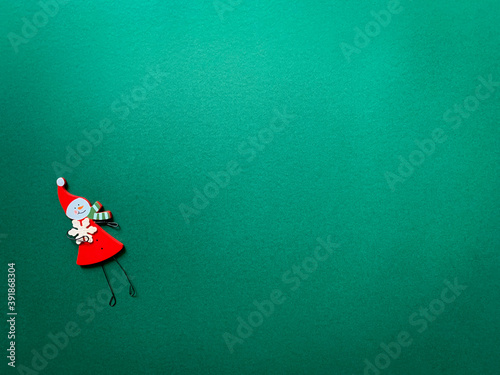 Christmas angel on a green background. Wooden Christmas decoration. Flat lay. Copy space.