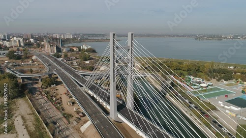 Aerial footage of a suspended bridge in Bucharest on a sunny day photo