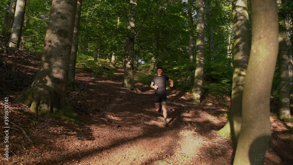 Runner runs down slopes in the mountains. Slow Motion Runner runs down slopes in the mountains. Slow Motion