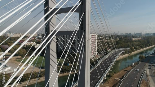 Aerial footage of a suspended bridge in Bucharest on a sunny day photo