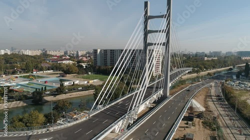 Aerial footage of a suspended bridge in Bucharest on a sunny day photo