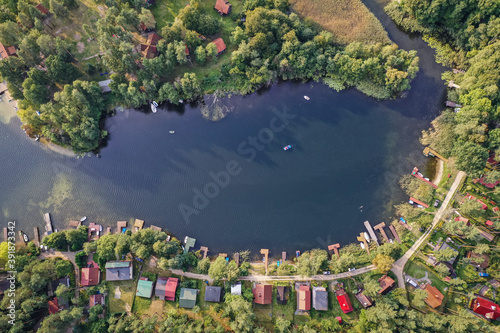 Drone view of summer cottages over Narie lake of Ilawa Lake District in Kretowiny  small village in Warmia Mazury region of Poland