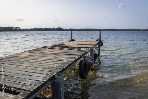Fototapeta Naklejka Na Ścianę i Meble -  Small pier on Narie lake of Ilawa Lake District in Kretowiny, small village in Warmia Mazury region of Poland
