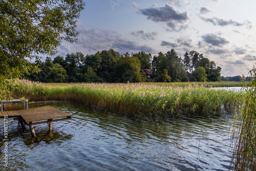 Fototapeta Naklejka Na Ścianę i Meble -  Shore of the Narie lake of Ilawa Lake District in Kretowiny, small village in Warmia Mazury region of Poland