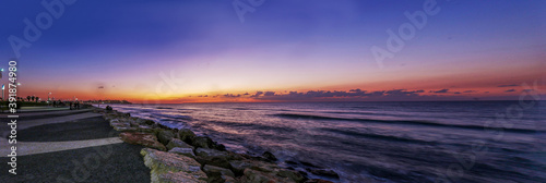 Coastline and pink sunset over Mediterranean Sea in Tel Aviv. Winter journey to warm Israel.