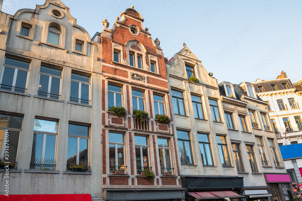 Historic architecture with colourful shopfronts in central Brussels at sunset in winter