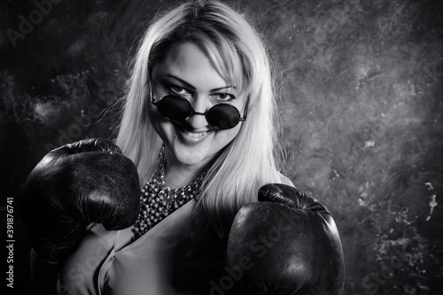 Attractive plump woman with boxing gloves bw studio portrait photo