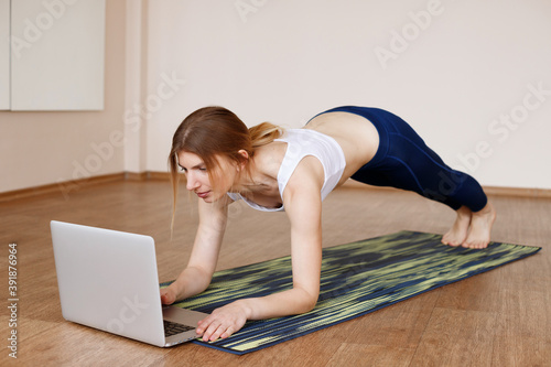 Girl does yoga online at home