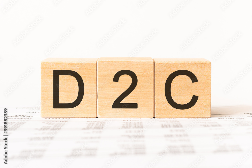 Word d2c. Wooden small cubes with letters isolated on white background with copy space available Word d2c. Wooden small cubes with letters isolated on white background with copy space available