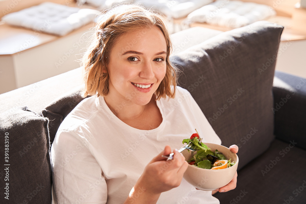 Woman holding plate with salad Woman holding plate with salad