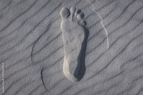 Male foot mark on a beach in Debki resort village on the Baltic Sea coast in Pomerania region of Poland photo