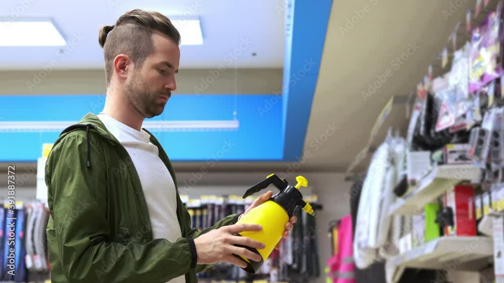 shopping in automobile goods store, choosing sprayer