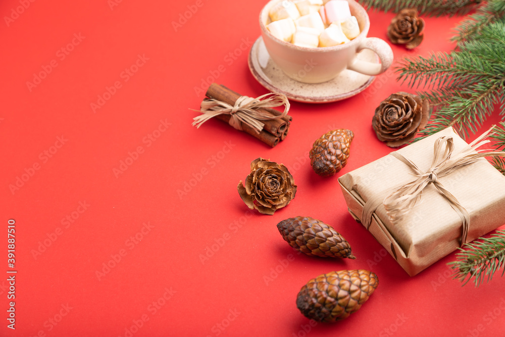 Christmas or New Year composition. Decorations, cones, fir and spruce branches, cup of coffee, on a red background. Side view, copy space. Christmas or New Year composition. Decorations, cones, fir and spruce branches, cup of coffee, on a red background. Side view, copy space.