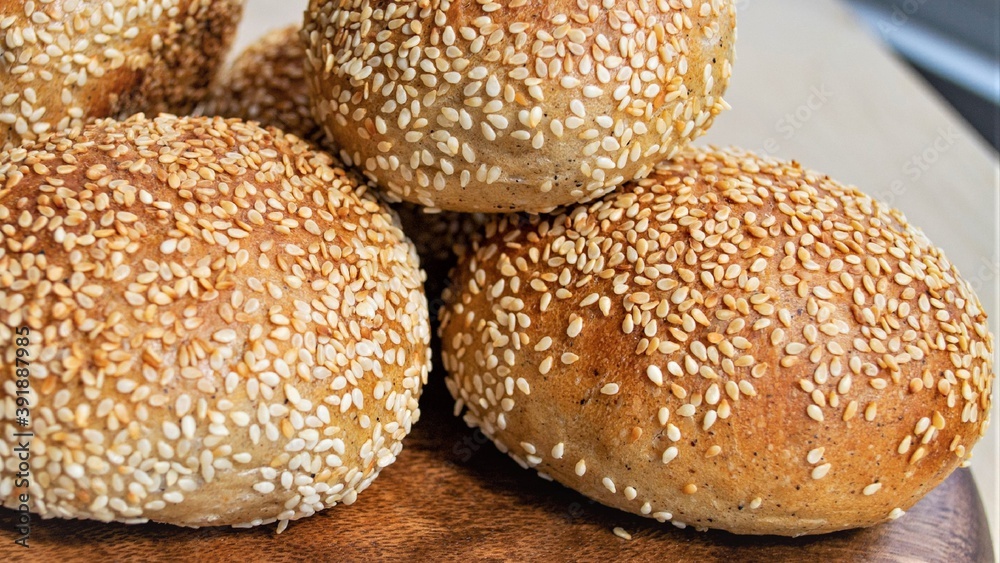 Composition in natural light. Homemade rye German buns with sesame seeds. Close-up Composition in natural light. Homemade rye German buns with sesame seeds. Close-up