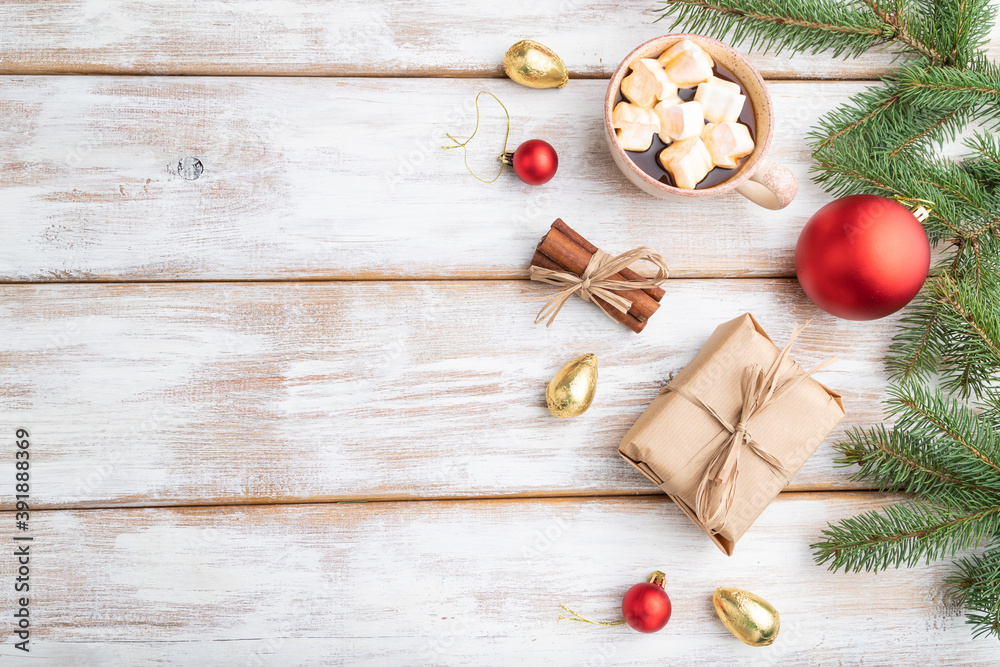 Christmas or New Year composition. Decorations, box, balls, fir and spruce branches, cup of coffee, on a white wooden background. Top view, copy space.