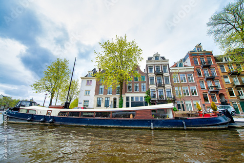 Amsterdam canals and boats with buildings, The Netherlands