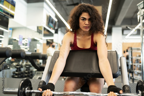 Portrait of a young woman doing weight lifting exercises