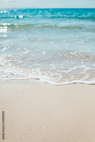 Soft blue ocean wave on sandy beach. Background.