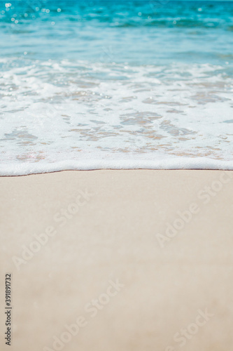 Soft blue ocean wave on sandy beach. Background.