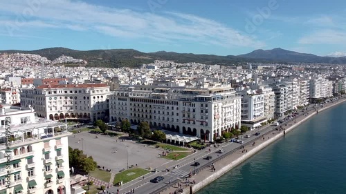 Aerial shot of Aristotelous square in the center of Thessaloniki, Greece, street with cars and urban coastline, moving forward and down  by drone photo