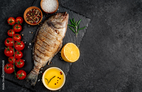grilled dorado fish with spices on a stone background with copy space 