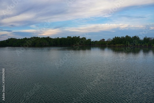 Natural blue sea in the territory of Indonesia there are trees and blue clouds.