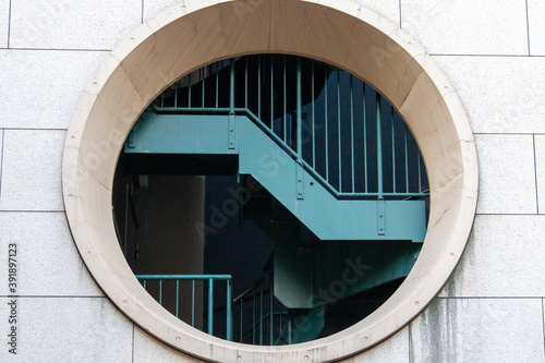Round window and staircase photographed from the outside