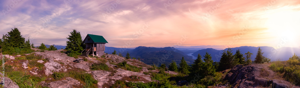 View of Tin Hat Cabin on top of a mountain. Dramatic Colorful Sunset Art Render. Located near Powell River, Sunshine Coast, British Columbia, Canada.