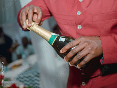 opening a bottle of champing is something that best man should  do before best man's toast. photo