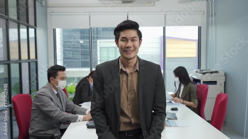 Asian businesspeople take off face mask and smile with confident 