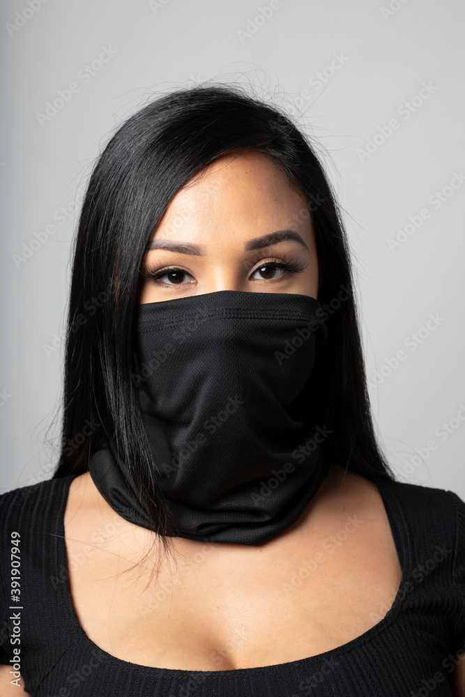 Mixed-Race woman wearing a black gaiter. Studio shot on white. Mixed-Race woman wearing a black gaiter. Studio shot on white.