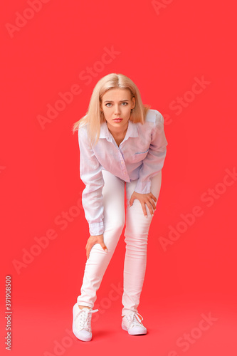 Slika na platnu Woman with problem of limbs numbness on color background