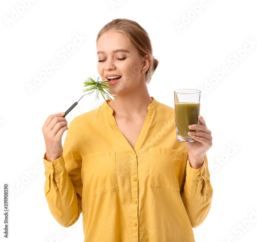 Young woman with wheatgrass...