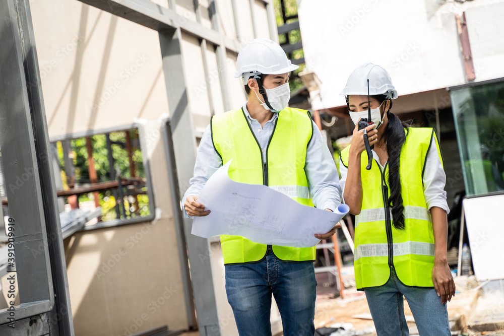 Asian young engineer woman talking with worker team by walkie-talkie.