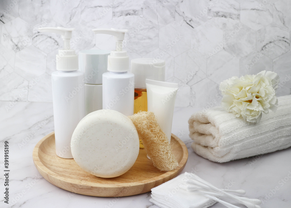 Baht accessories on wooden tray contain of soap, lotion, loofah, oil and towel - Body care and personal hygiene concept on marble background Baht accessories on wooden tray contain of soap, lotion, loofah, oil and towel - Body care and personal hygiene concept on marble background
