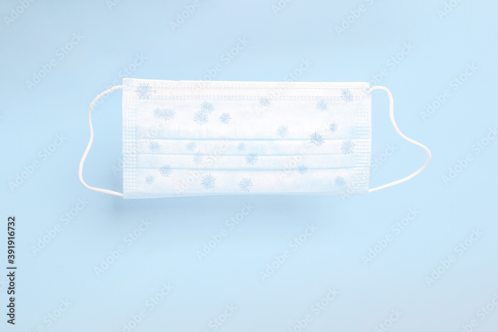 Medical face mask with xmas print of snowflakes for Christmas and New Year. Protection of population during epidemic, Corona virus-COVID19 Medical face mask with xmas print of snowflakes for Christmas and New Year. Protection of population during epidemic, Corona virus-COVID19