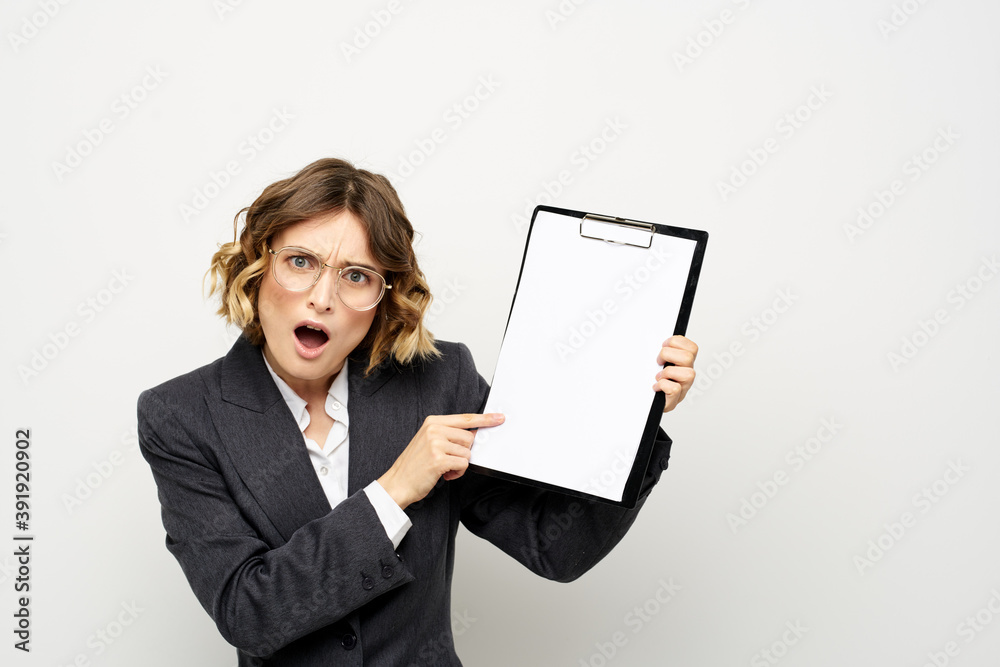 Business woman with a folder of documents on a light background cropped view and shirt suit Business woman with a folder of documents on a light background cropped view and shirt suit