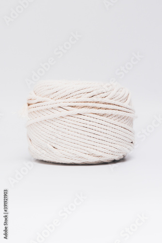 Cotton ropes are material for macrame weaving. Over the white background surface. Flat lay, top view. Step by step instructions for macrame weaving.