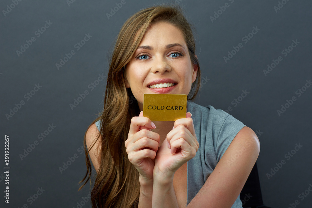 Face close up portrait of woman with big toothy smile holding credit card. Face close up portrait of woman with big toothy smile holding credit card.