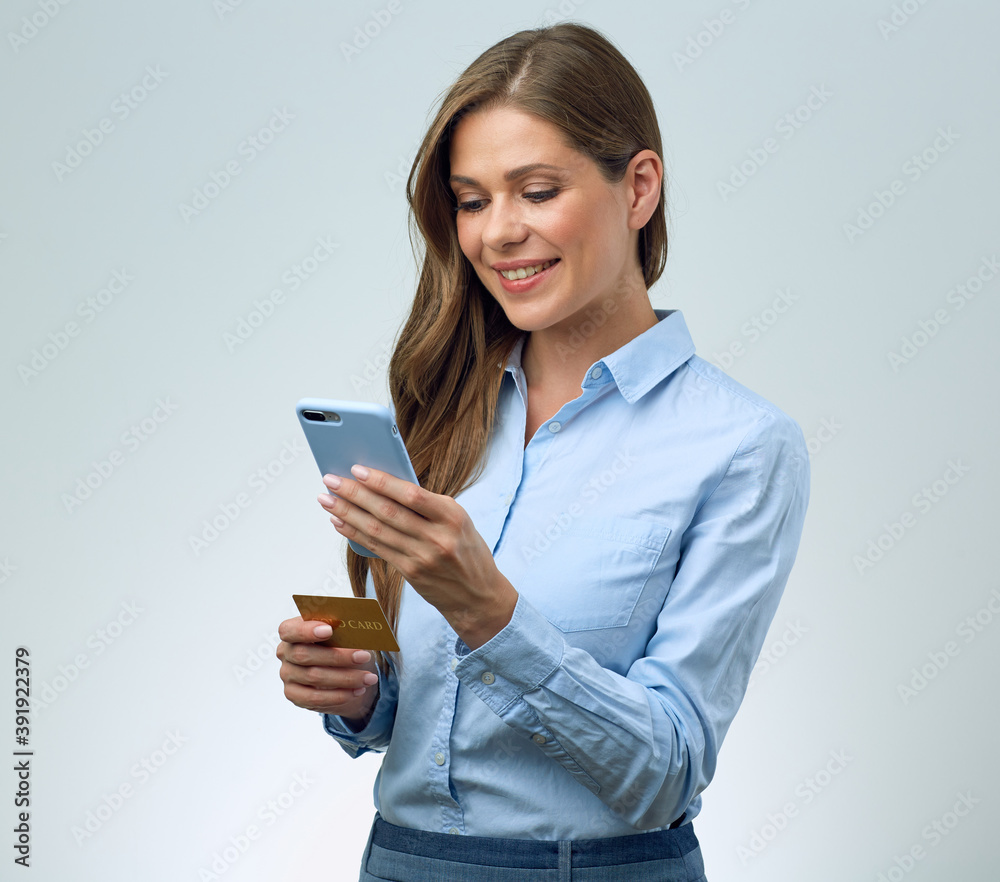 Woman using cell phone and credit card for on line banking. Woman using cell phone and credit card for on line banking.