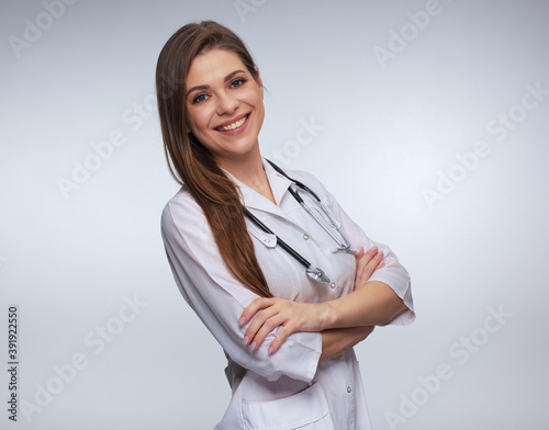 Woman doctor dressed white uniform posing with crossed arms.